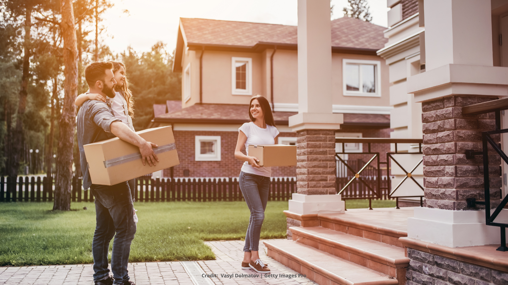 Picture of family moving into home